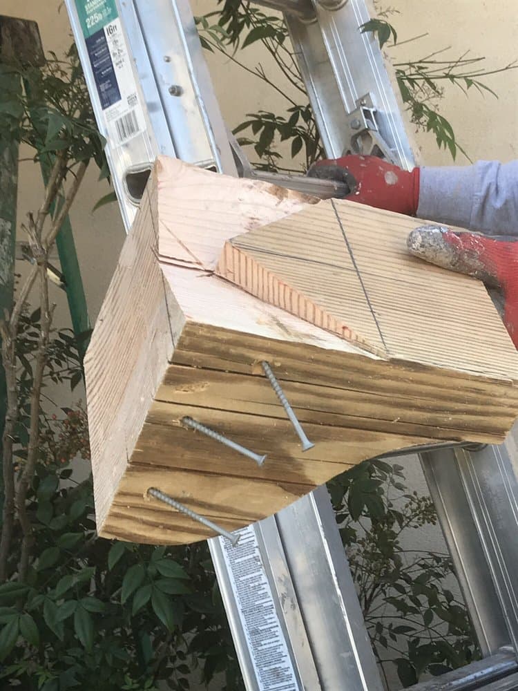 New replacement rafter being shaped with structural screws to match the existing roofline.