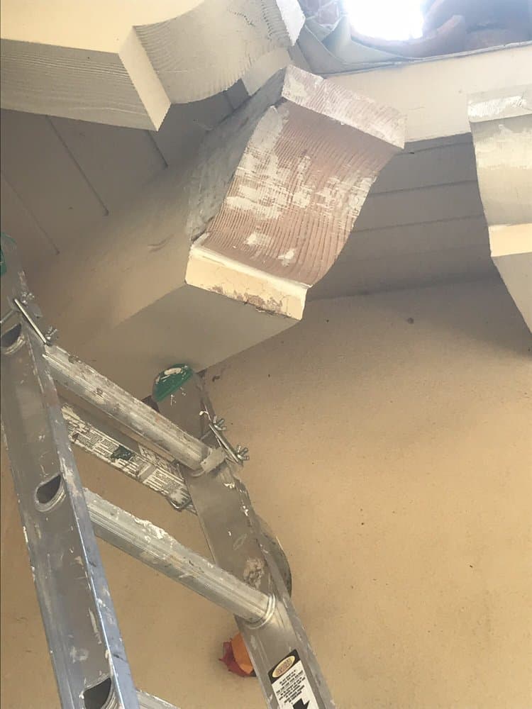 Same eave corner after repair — sealed, primed, and ready for finish paint.